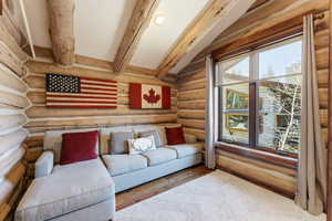 Living area featuring hardwood / wood-style floors and log walls