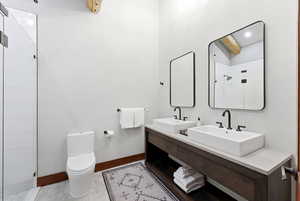 Bathroom with a tile shower and double vanity