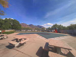 Community pool featuring a mountain view and a patio