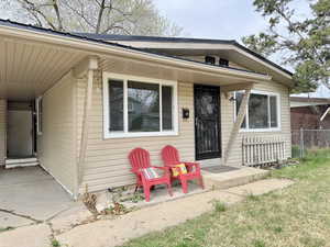 Doorway to property with a carport