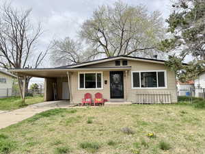 View of front of home featuring an attached carport and concrete driveway