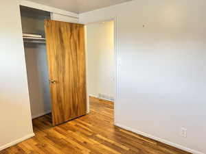 Unfurnished bedroom featuring a closet and light wood-style floors