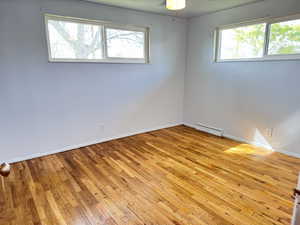 Unfurnished room featuring light wood-type flooring and ceiling fan