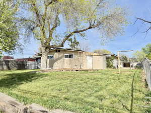 View of side of home featuring a fenced backyard