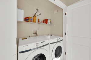 Laundry area with washing machine and clothes dryer