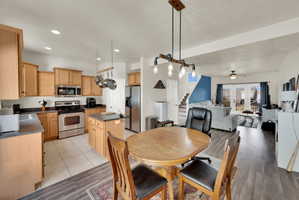 Dining room with a ceiling fan, recessed lighting, and light wood-type flooring