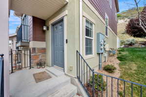 View of exterior entry with stucco siding