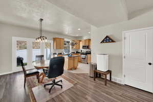 Dining area with light wood-style floors and hanging lights