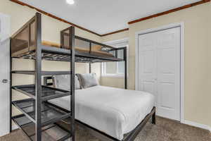 Bedroom featuring carpet flooring and a closet