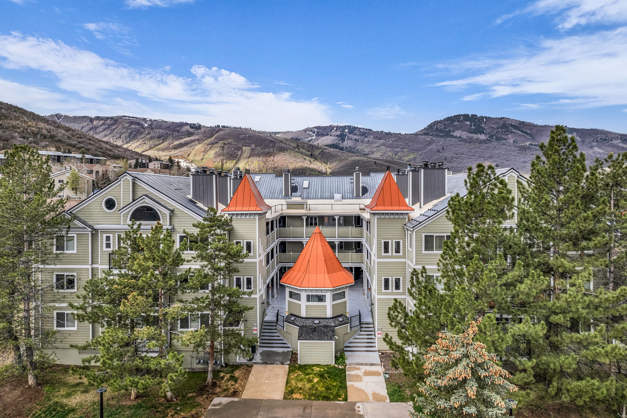 View of building exterior featuring a mountain view and stairway