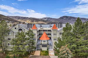 View of building exterior featuring a mountain view and stairway