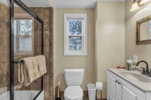 Full bathroom with vanity and combined bath / shower with glass door