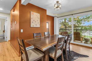 Dining space featuring light wood-style flooring and hanging lights