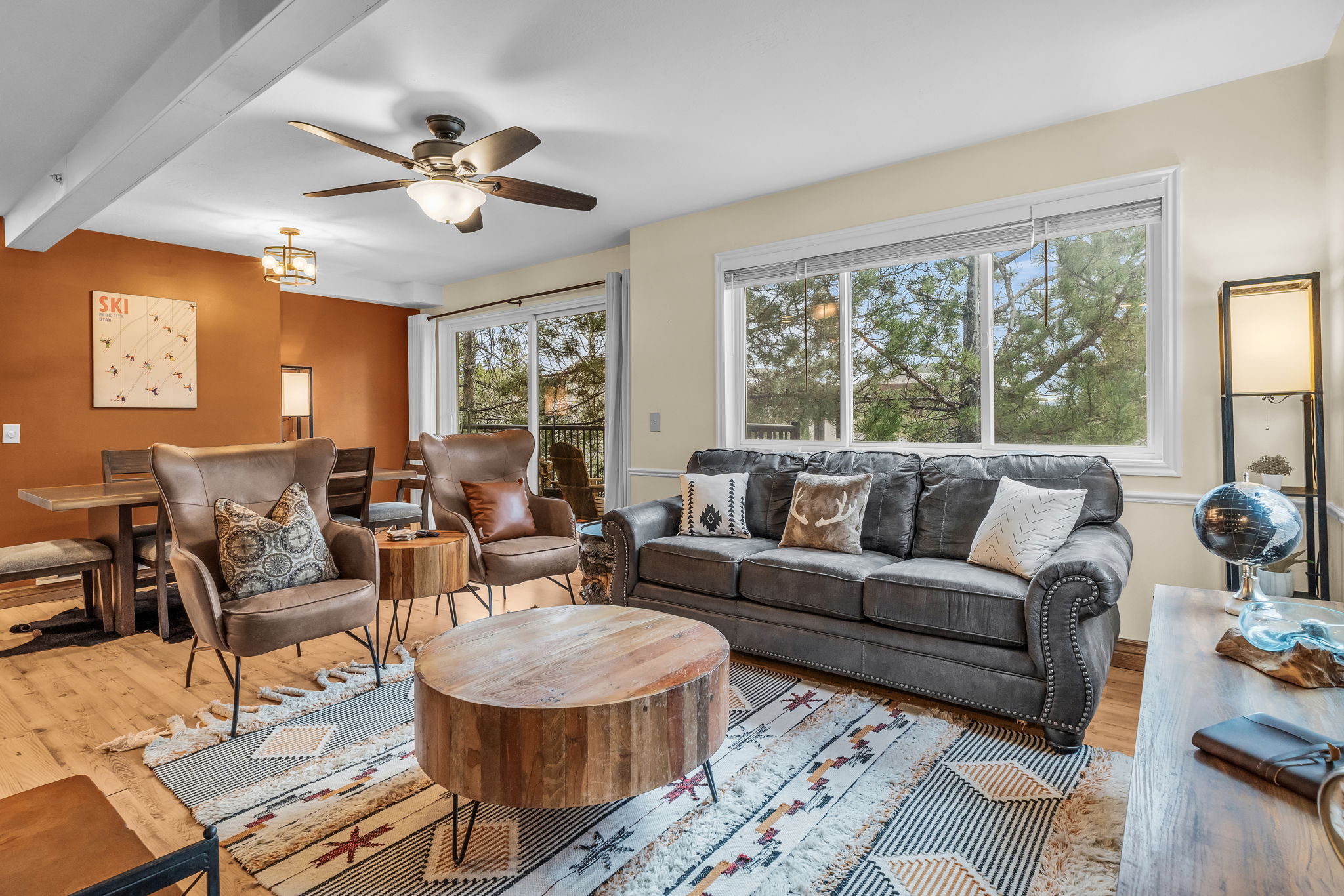 Living room with wood-type flooring, ceiling fan, and beamed ceiling
