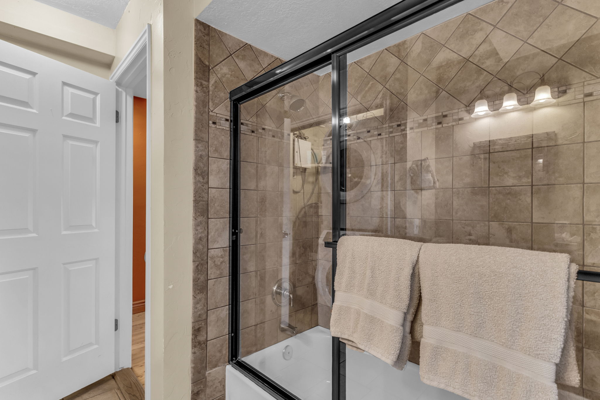 Full bathroom featuring shower / bath combination with glass door