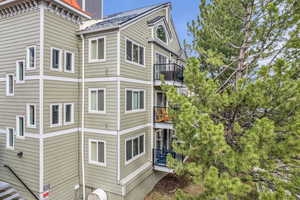 View of side of home featuring a balcony