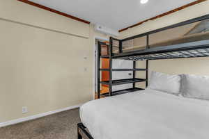 Bedroom with carpet flooring and baseboards