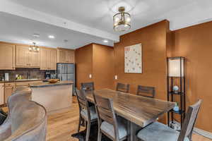 Dining space featuring hanging lights and light wood-type flooring