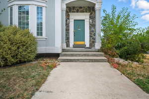 Doorway to property with stone siding