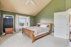 Bedroom with carpet flooring, lofted ceiling, and ceiling fan