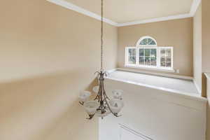 Detailed view of crown molding and a chandelier