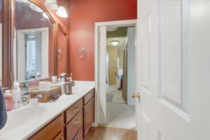 Bathroom featuring double vanity and light wood-style floors