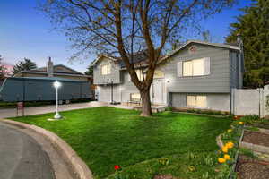 Bi-level home featuring driveway and a garage