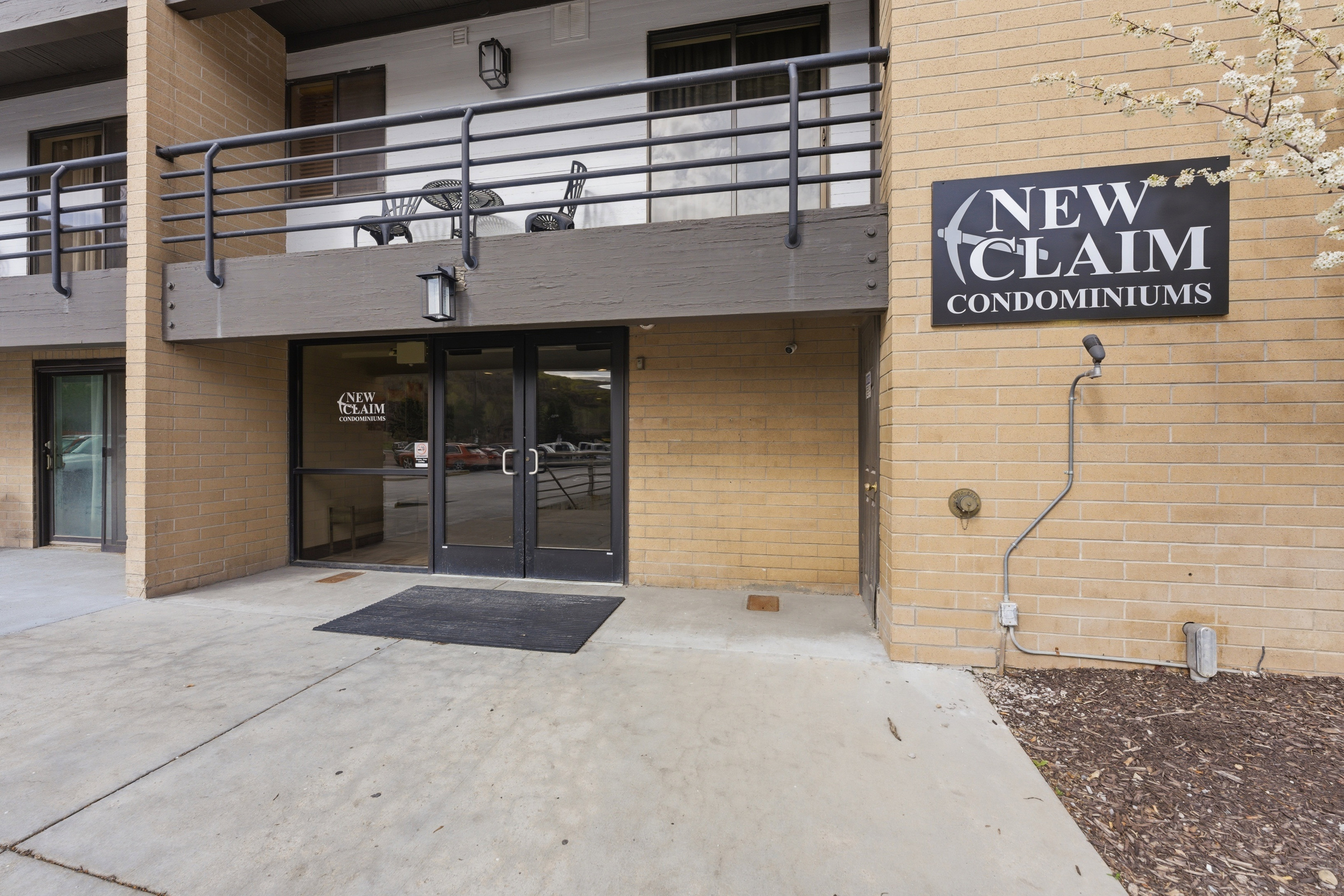 Entrance to property featuring brick siding