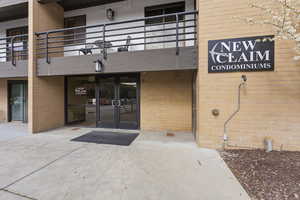 Entrance to property featuring brick siding