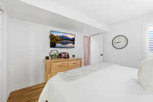 Bedroom featuring light wood finished floors and baseboards