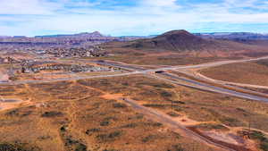 Aerial view of sparsely populated area featuring a mountain backdrop and a desert landscape