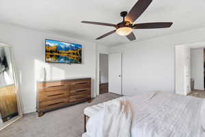 Bedroom featuring a ceiling fan and light carpet