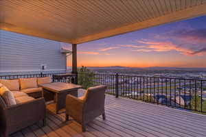Wooden terrace with outdoor furniture and a mountain view
