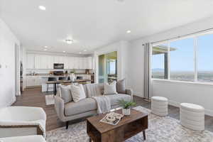 Living area featuring wood finished floors, plenty of natural light, and recessed lighting