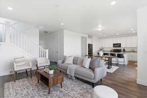 Living room featuring dark wood-type flooring and recessed lighting