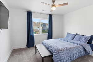 Bedroom with light carpet and ceiling fan