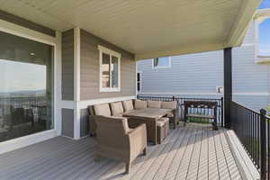 Wooden terrace featuring an outdoor lounge area