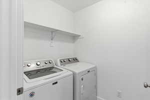 Laundry room with washing machine and clothes dryer