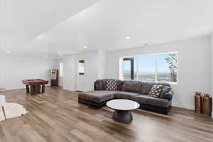 Living room featuring light wood-style flooring and recessed lighting