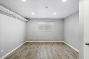 Spare room featuring light wood-type flooring and recessed lighting