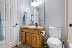 Full bathroom with vanity and suspended lighting