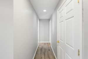 Hall featuring recessed lighting and wood finished floors