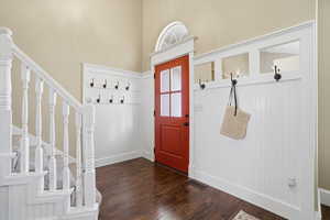 Mudroom with dark wood-style floors and baseboards