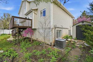 View of side of property featuring a shed and a wooden deck