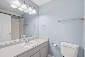 Bathroom featuring vanity and a shower
