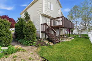 Rear view of property featuring a deck and stairway