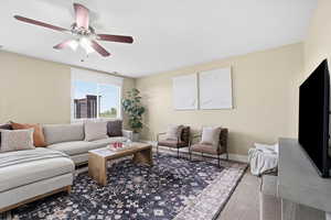 Living room with ceiling fan and baseboards