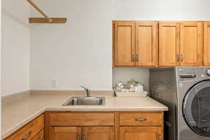 Laundry room featuring washer / dryer and cabinet space