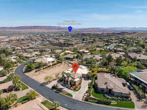Aerial overview of property's location featuring a mountainous background and nearby suburban area