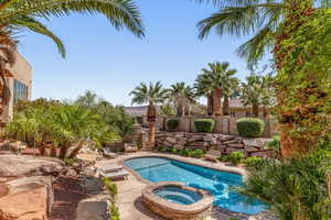 Combined pool / hot tub with a patio area